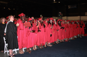Members of the Class of 2013 move their tassels from the right to left, making them official graduates.