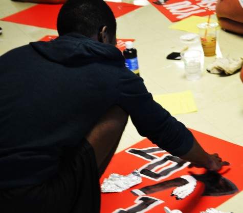 Jahsia Cooper paints the 2015 sign.