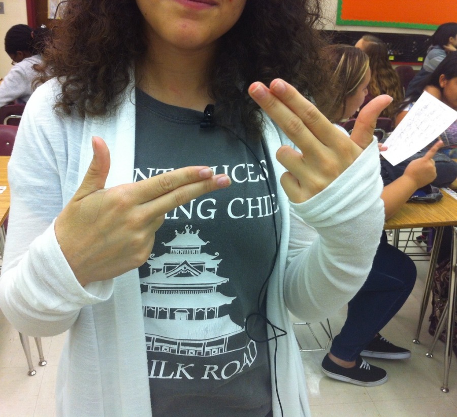 Junior Alexis Treviño uses the sign for sign language.