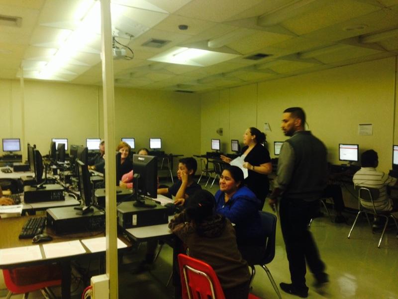 Ms. Asen and Mr. Ramos administer the computer-based test to parents.
