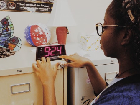 Johanne Damiscar adjusting the time in her classroom. 
