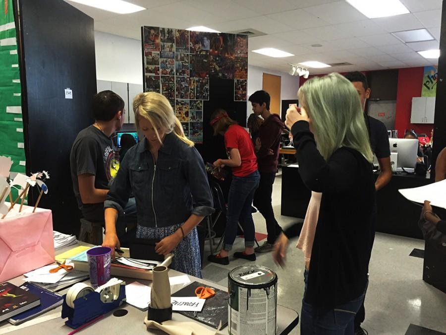Photography students busy at work to set up their art show displays