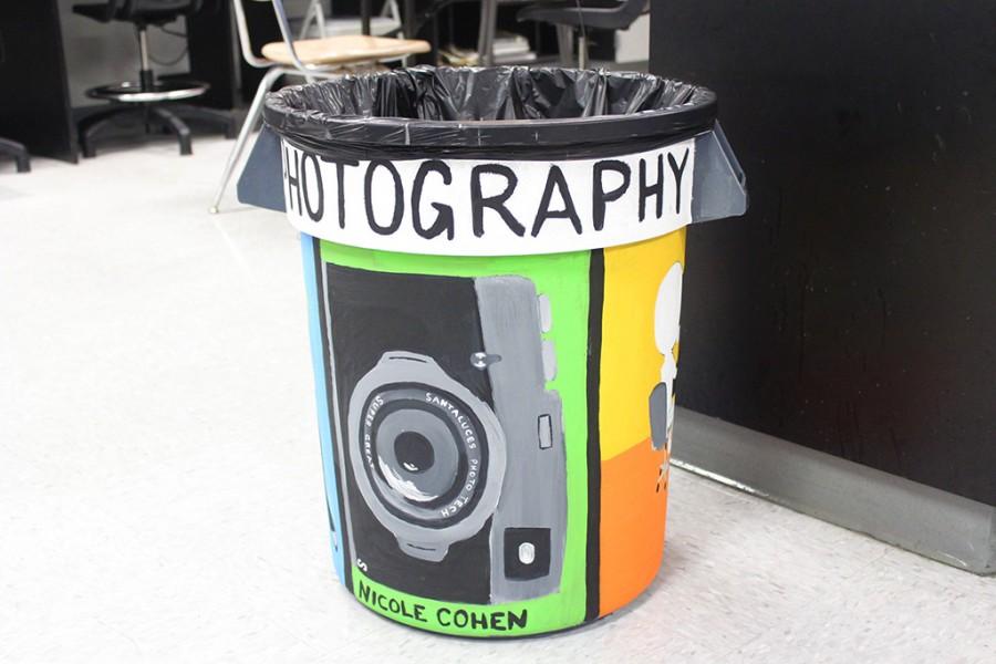 A garbage can gets a paint job from Senior Nicole Cohen.