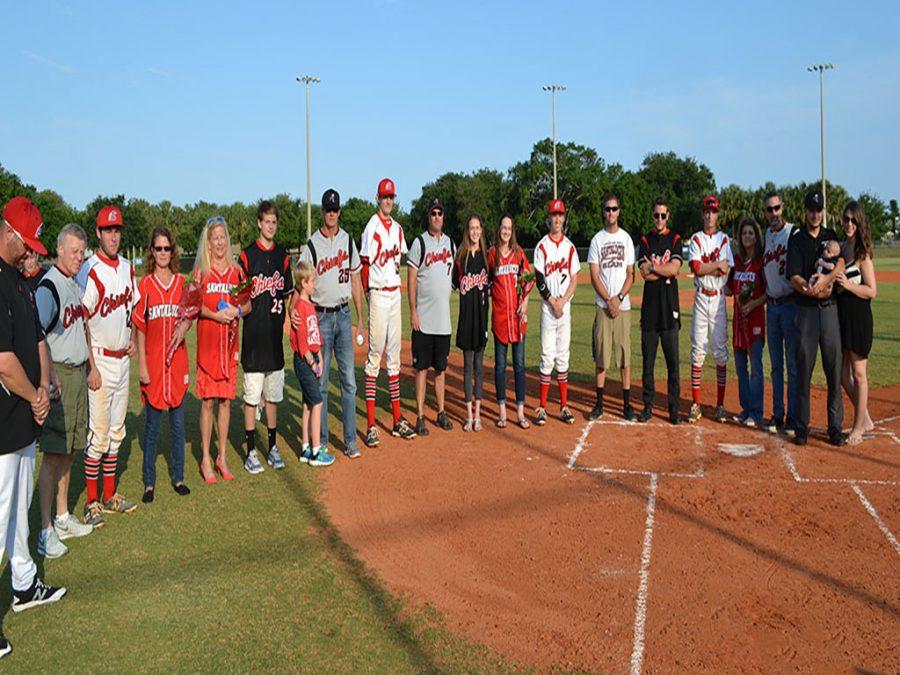 Seniors with their escorts surround home plate.