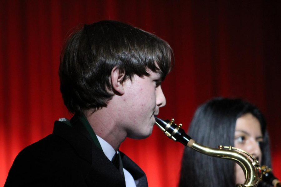 Ryan Jayne playing saxophone during the jazz band performance 