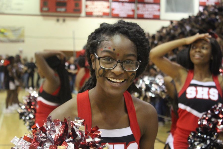 A cheerleader smiles after performing for the rest of Santaluces during the pep rally. 