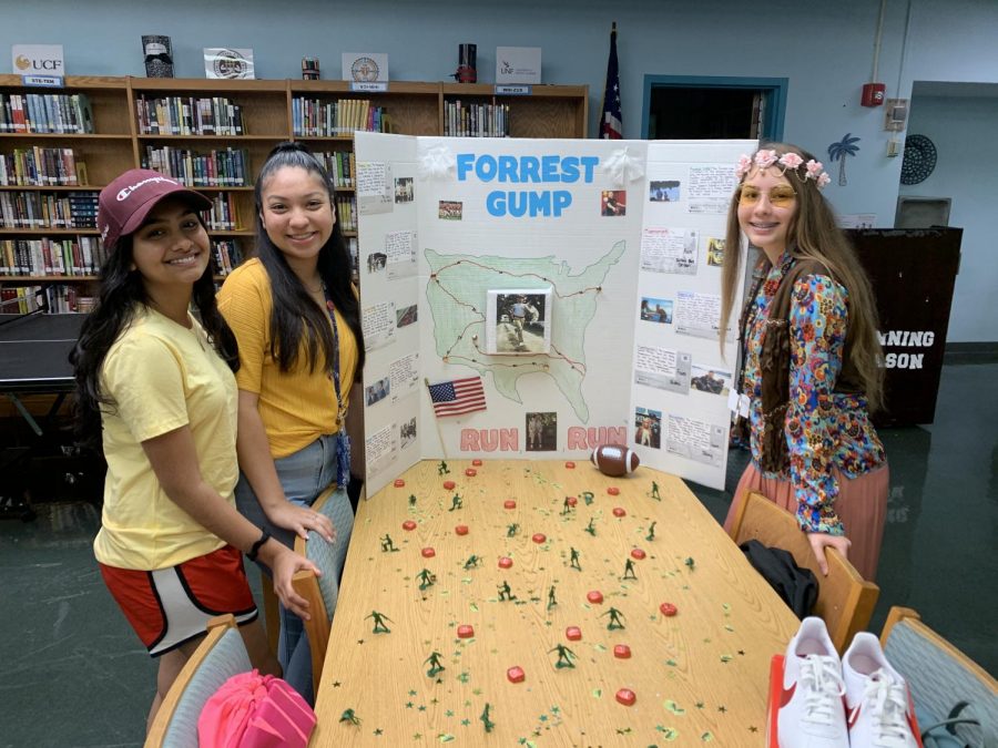 Myesha Rahman, Megan Searing, and Michaela Joinvill showing off their project on Forrest Gump.