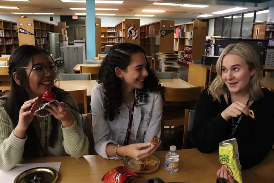 Students, Alayna Reddick, Lauren Klemowich and Sabrina Luu, chatting and eating their treats.