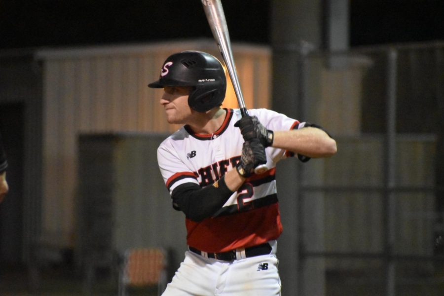 Senior Eathyn Little practices his swing before getting up to bat.