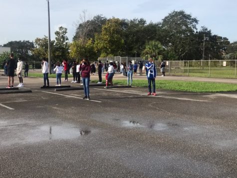 Students stood in the empty teacher parking lot during the first fire drill of the year.