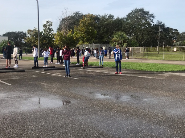 Students stood in the empty teacher parking lot during the first fire drill of the year. 