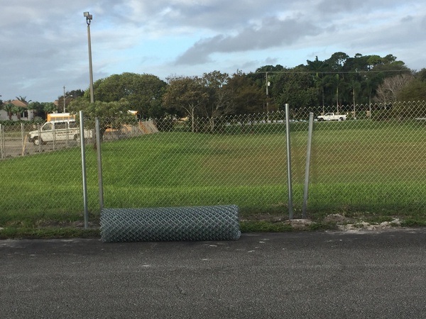 New fencing awaits installation in the faculty parking lot. 