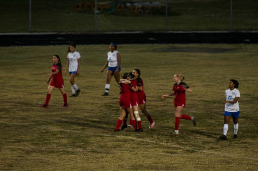 The Girls Soccer Team celebrating during a game. 