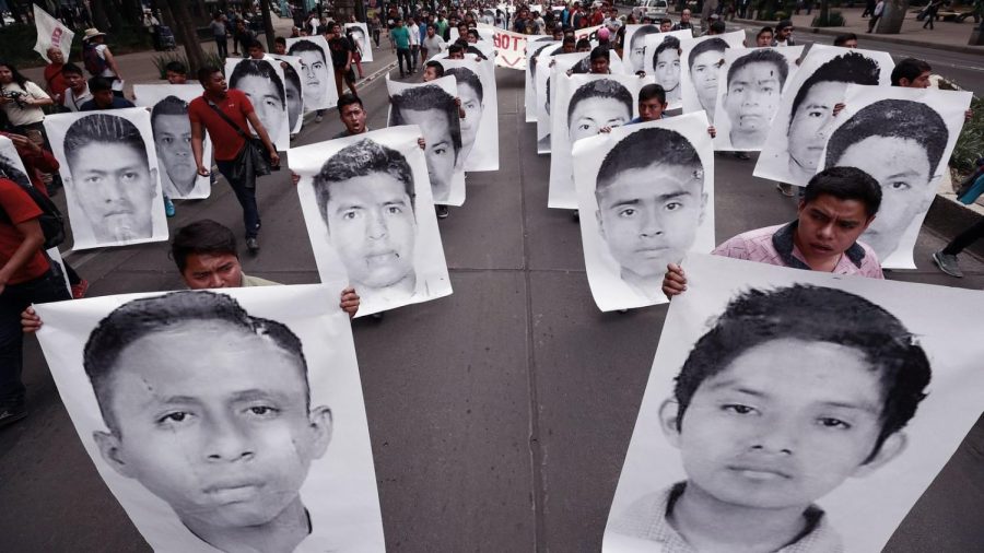 People holding up the faces of the missing.