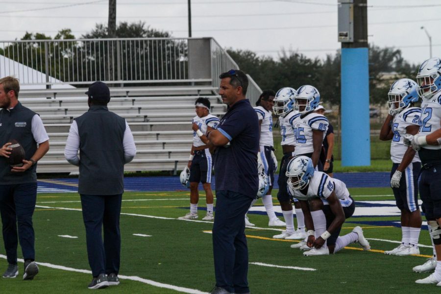 Keiser University Head Football Coach Doug Socha looks on during a practice.