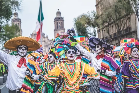 People gather in traditional clothing and face paint to celebrate the Day of the Dead.