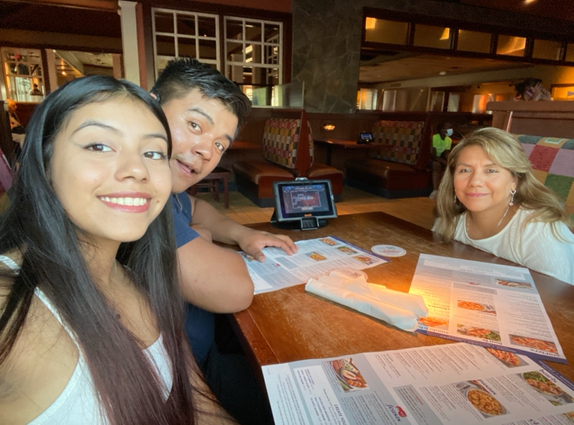 Cindy enjoying an evening out to dinner with her mom and brother.