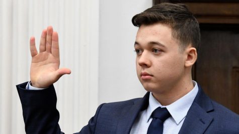 18 year old Kyle Rittenhouse raising his right hand as he is about to approach the stand to testify.