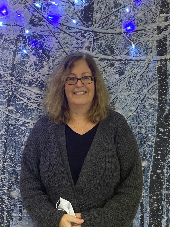Ms. Lupu is inside her decorated classroom that is a winter theme. 