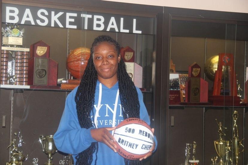 Brtiney Chery receives a commemorative ball for achieving 500 career rebounds.