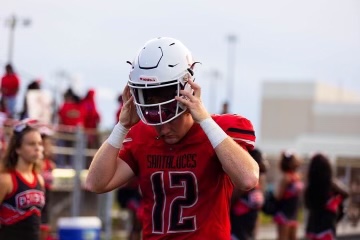 Will Prichard removes his helmet as he approaches the sideline.