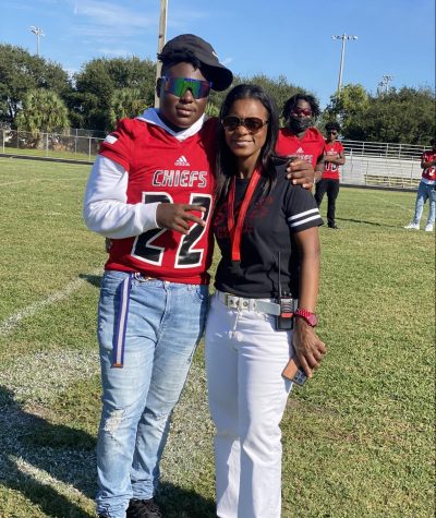 Tre and his mom on the football field.