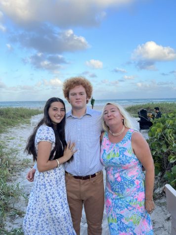 Will at the beach taking pictures with his mom and girlfriend.