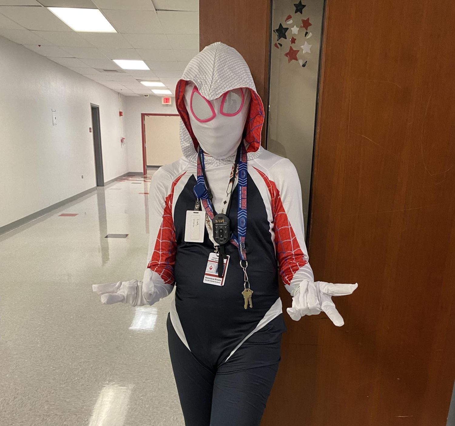 Ms.Kivela in front of her classroom wearing her Spiderman costume.