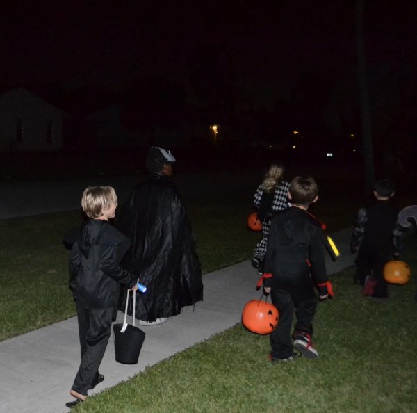 A picture of kids trick-or-treating on Halloween. 