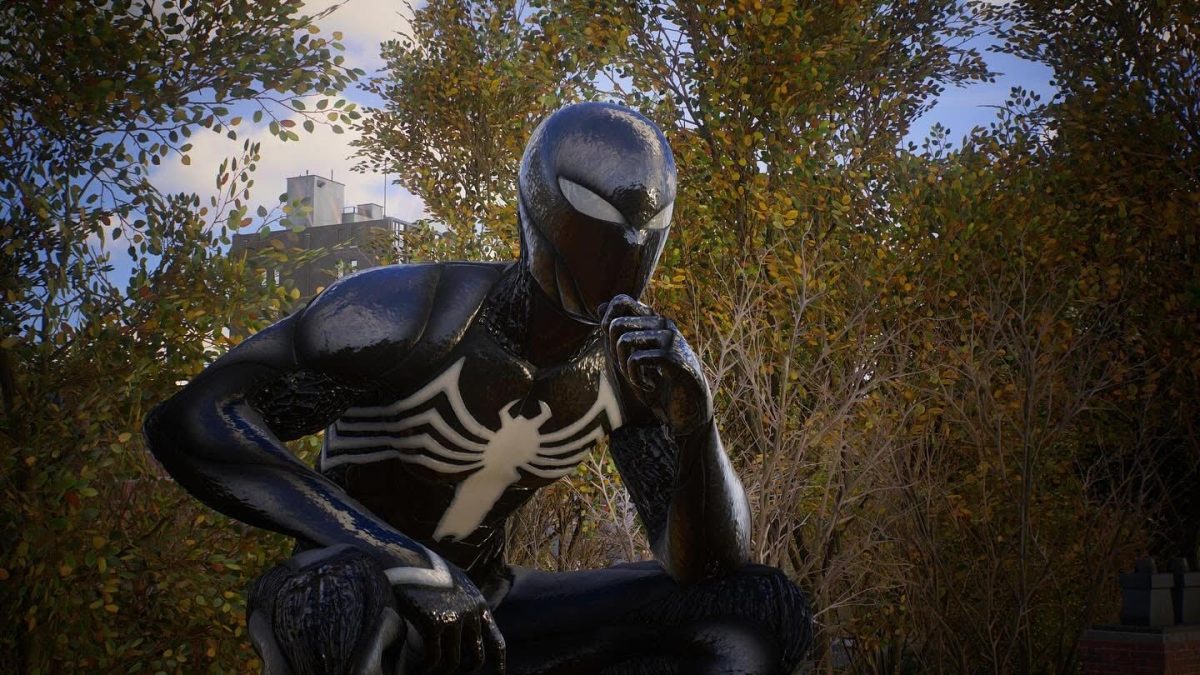 Spider-Man wincing in his Black Suit. This photo was taken by the in-game Photo Mode provided by Sony Interactive Entertainment and Insomniac Games.