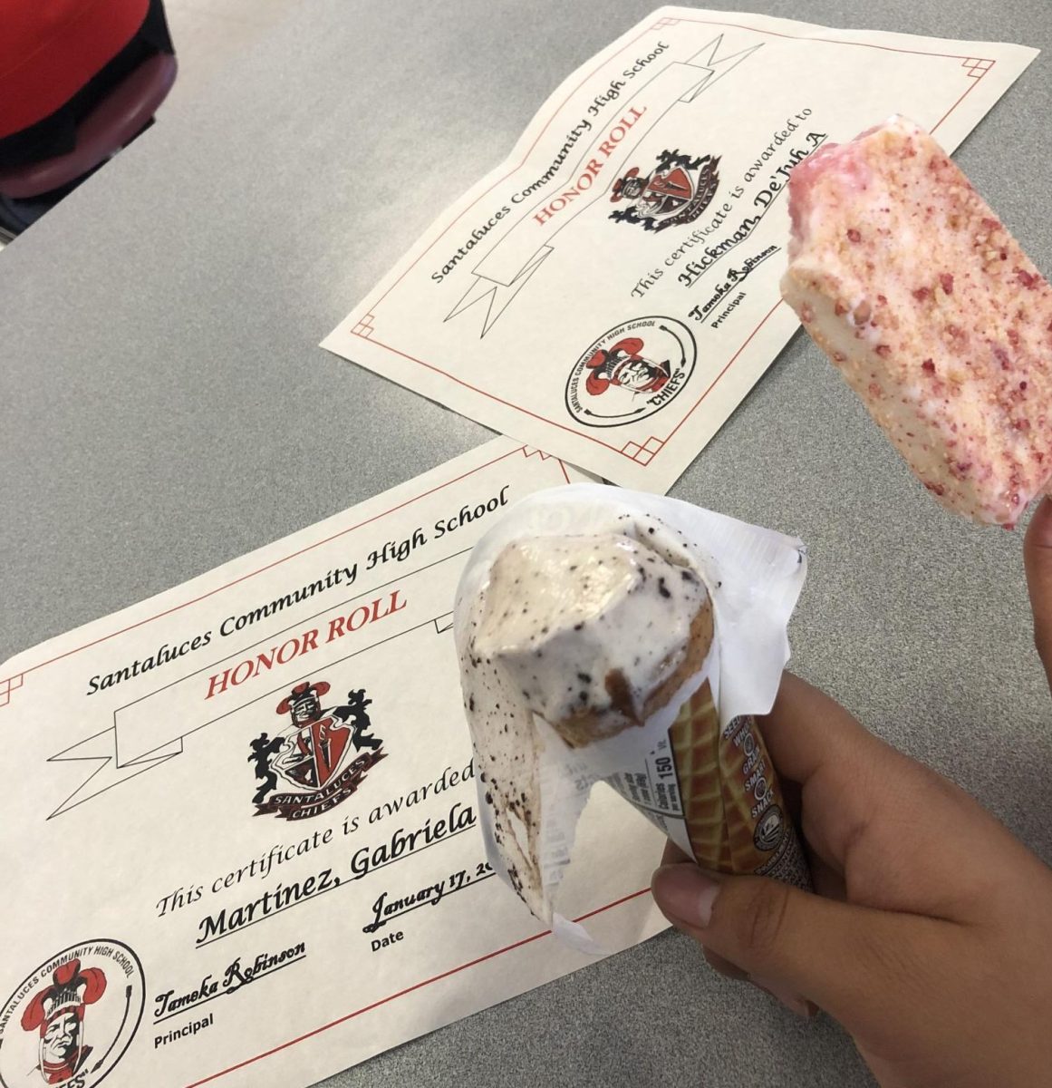 Me(Dejuh) and Gaby showing off our honor roll certificates while enjoying our strawberry shortcake and oreo ice creams.