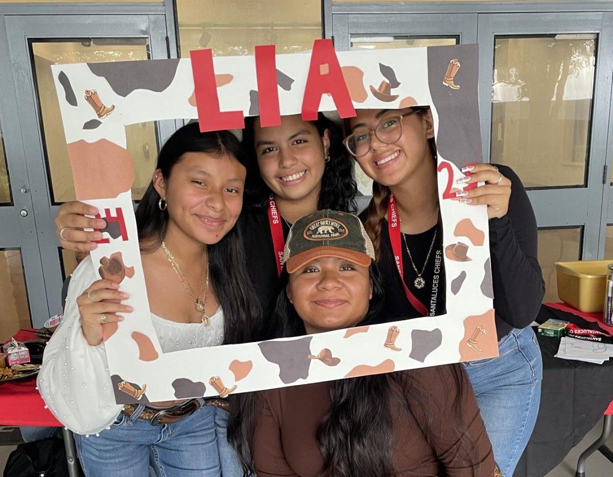 Students holding a Latinos In Action sign.