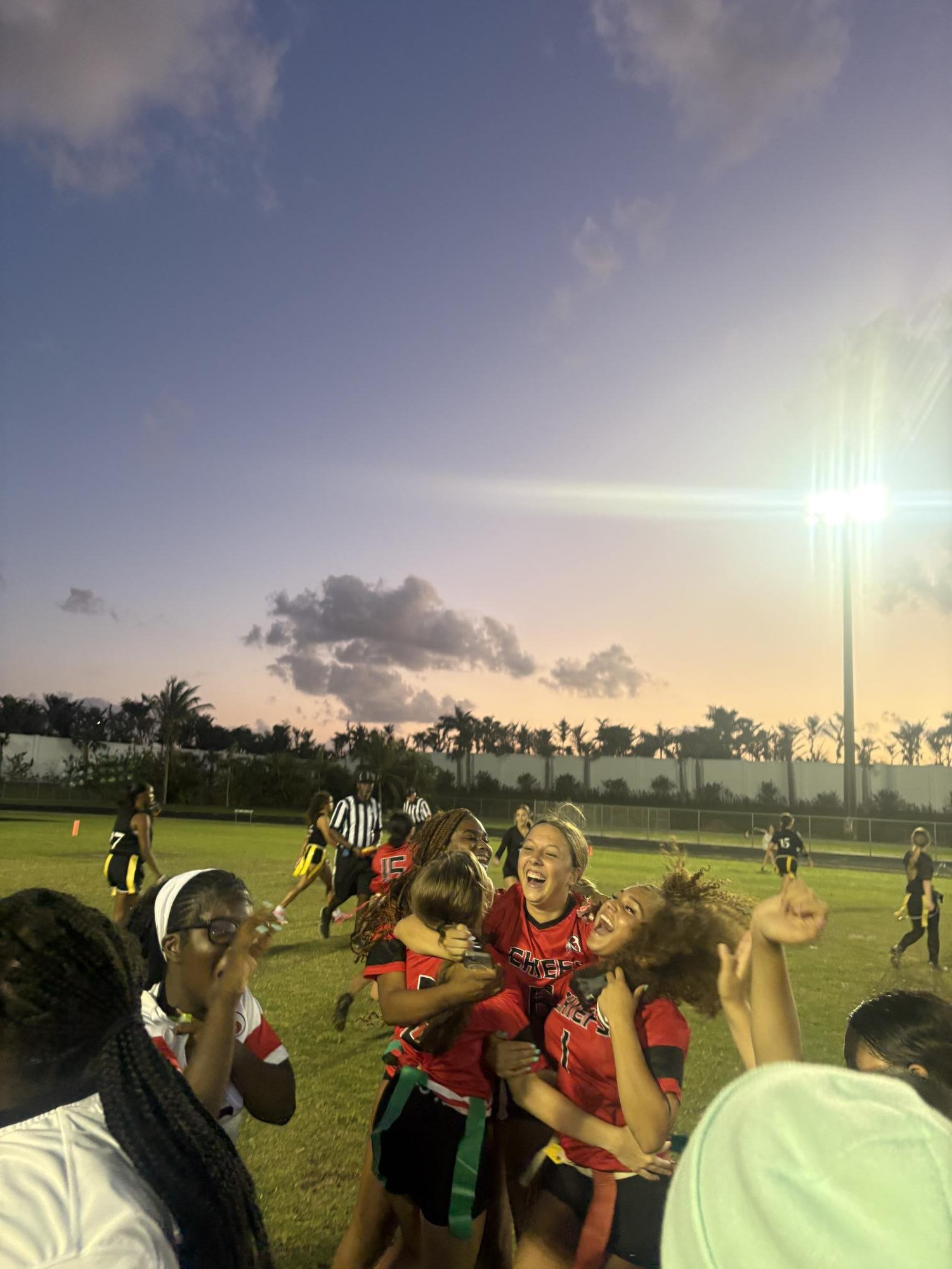 The girls celebrating a touchdown at Olympic Heights high school. 